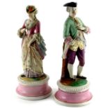 A pair of late 19thC continental bisque porcelain figures, modelled in the form of a gentleman and l