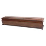 A mahogany sarcophagus shaped sword case, with brass presentation plaque, engraved Shotley Bridge, c