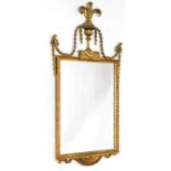 A 19thC continental giltwood wall mirror, the crest decorated with fleur de lys, above an urn issuin