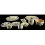 A collection of Poole Pottery, each piece decorated with flower sprays in a typical style, printed m