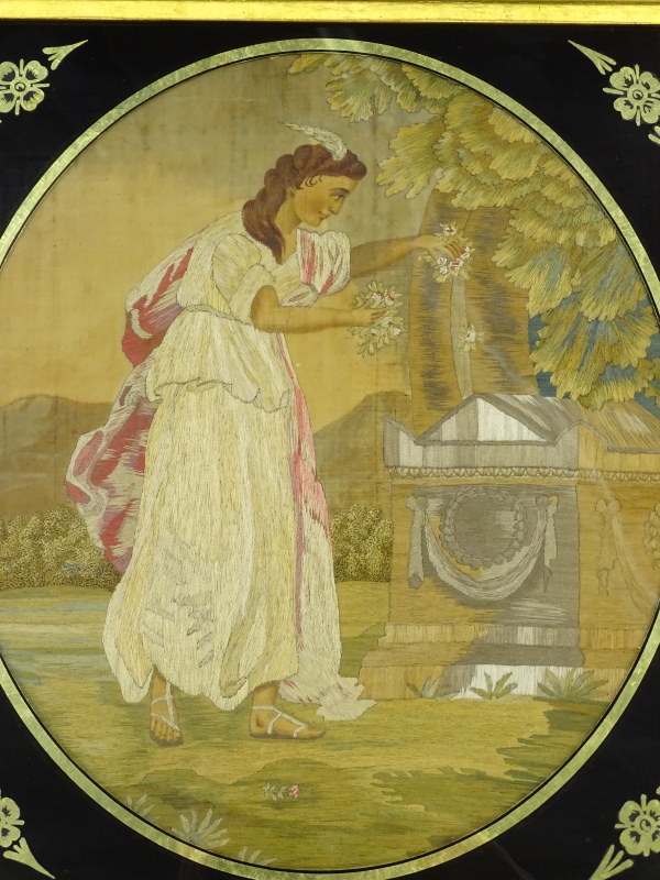 An early 19thC silk embroidered picture, depicting of a lady with flowers beside a grave, within Ver - Image 2 of 2