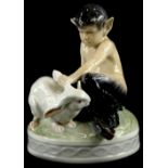 A Royal Copenhagen porcelain figure group, model in the form of a fawn, holding a rabbit, on a circu