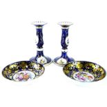 A pair of Derby porcelain saucers, each decorated centrally with flowers, sprays, within cobalt blue