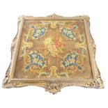 A Victorian embroidered pole screen banner, decorated with flowers within a gilt gesso frame, (AF),