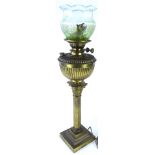 A late 19th/early 20thC brass Corinthian column oil lamp, on a square step base and a frosted green