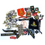 A quantity of military cap badges or tallies, military patches, badges, etc.