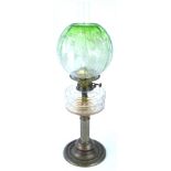 A Victorian brass oil lamp, with reeded column and leaf cast base, with a green globular etched flor