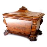 A William IV figured mahogany sarcophagus shaped wine cooler, the hinged domed lid carved with grape