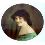 A 1930s porcelain plaque, painted with a portrait of a young lady, by James Edwin Dean, 25cm diamete