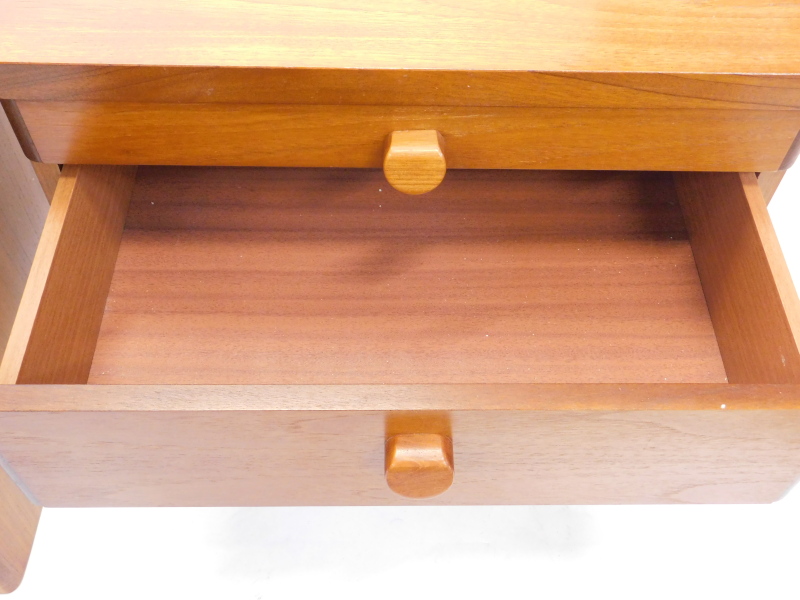 A Stag teak bedside cabinet, with three drawers, shaped handles, on a plinth base, 55cm high, 56cm d - Image 2 of 2