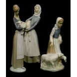 A Spanish porcelain figure of a lady with sheep, and two similar Lladro figurines. (3)