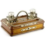 A Victorian oak and silver plated inkstand, of rectangular form, with two inkwells, presentation car