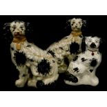 A pair of Staffordshire type open toed spaniels, another similar. (3)