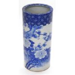 A late 19th/early 20thC Japanese blue and white cylindrical umbrella stand, decorated overall with f
