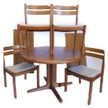 A Dyrlund Danish teak extending dining table, with a circular top on a cruciform type column, with f