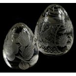 Two similar egg shaped clear cut glass paperweights, 5cm and 4cm high, respectively.