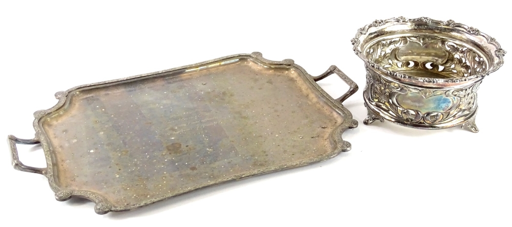 A silver plated dish base, decorated with scrolls, leaves, etc., with two vacant cartouches, possibl