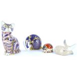 Three Royal Crown Derby porcelain paperweights, a cat, a badger, and a ladybird, gold button to lady