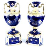 A pair of Staffordshire pottery two handled vases, each decorated in Imari colours within gilt borde