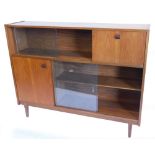 A 1970's/80's teak side cabinet, with two pairs of sliding doors, a fall front door and a single doo