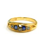 An 18ct gold sapphire and diamond set gypsy ring, set with two sapphires and design for four diamond