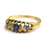 An 18ct gold sapphire and diamond set gypsy ring, set with three sapphires and two diamonds, each in