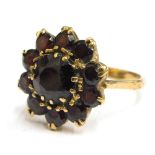 A 9ct gold garnet floral cluster ring, with circular cut garnets in claw setting, ring size Q, 5.1g