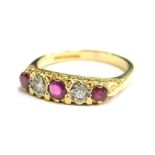 An 18ct gold ruby and diamond set gypsy ring, set with five stones, comprising three rubies and two