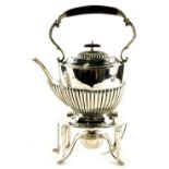 An Edwardian silver kettle on stand, with an ebonised handle and knop, part fluted body on oval stan