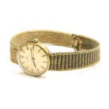 A 9ct gold Omega ladies wristwatch, with small circular dial, with gold coloured dial, on twist desi