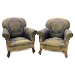 A pair of early 20thC mahogany armchairs, upholstered in gold and blue fabric, on shaped legs.