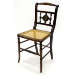 A Regency beech side chair, painted to simulated rosewood, with brass mounts, a cane seat on splayed