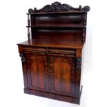 A Victorian mahogany chiffonier, the raised back decorated with scrolls and a lotus flower, above tw