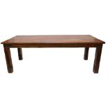 A hardwood dining table, with a planked top on plain legs, bound with iron mounts, 76cm high, the to