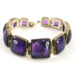 A silver and amethyst set graduated bracelet, each with square cut stones, boxed.