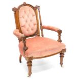 A Victorian walnut open armchair, the shaped back carved with ribbons, patera, etc., on fluted suppo
