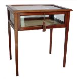 An Edwardian mahogany and boxwood strung display table, the rectangular glazed top with a hinged lid