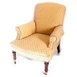 A Victorian style mahogany armchair, upholstered in gold and red fabric, with piped borders, on turn