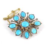 A turquoise and diamond set brooch, the brooch set with oval and round cut turquoise stones, held i