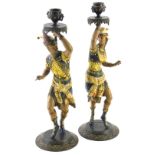 A pair of late 19th/early 20thC spelter figural candlesticks, each with classical urn dish holders,