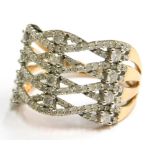 A 9ct gold dress ring, of four row cross weave design, in two sections, with a four row split should