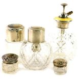 Various cut glass dressing table jars, each with silver mounts, to include a scent bottle with pump