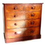 A Victorian mahogany chest of drawers, the top with rounded corners above two short and three long d