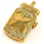 A brass novelty Vesta case, the hinged lid cast as a crown, the base cast with a vacant cartouche.