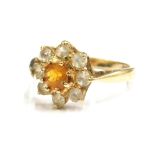 A 9ct gold cluster ring, set with central orange stone and surrounded by white stones, ring size K½,