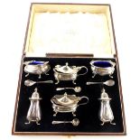 A George VI silver six piece cruet, comprising pair of mustard pots, a pair of open salts and a pair