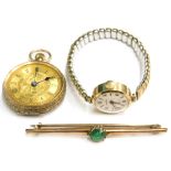 Three items of jewellery, comprising a 9ct gold green paste stone set bar brooch, a fob watch, and a
