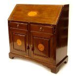 An Edwardian mahogany bureau, the fall inlaid with a shell enclosing a fitted interior, above two f