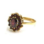 A 9ct gold garnet cluster ring, set with various oval cut stones in claw setting, ring size O, 2.6g