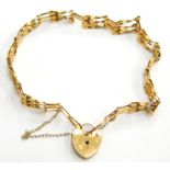 A 9ct gold gate bracelet, of three thin bar design, with small heart shaped padlock, and safety chai